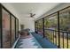 Spacious screened porch with ceiling fan, comfortable seating, and lush garden views at 842 Amelia Ne Ct, St Petersburg, FL 33702