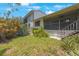 Landscaped backyard with a view of the home's screened porch at 842 Amelia Ne Ct, St Petersburg, FL 33702