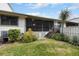 Private backyard with screened patio, deck, and lush landscaping at 842 Amelia Ne Ct, St Petersburg, FL 33702