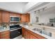 Stylish kitchen with stainless steel appliances and wood cabinets at 842 Amelia Ne Ct, St Petersburg, FL 33702