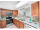 Well-equipped kitchen boasting stainless steel appliances and wood cabinets at 842 Amelia Ne Ct, St Petersburg, FL 33702