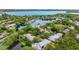 Aerial view of waterfront community with lush landscaping and lake access at 842 Amelia Ne Ct, St Petersburg, FL 33702