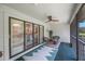 Relaxing screened porch with ceiling fan, comfortable seating, and a view of the backyard at 842 Amelia Ne Ct, St Petersburg, FL 33702
