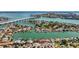 Scenic aerial view highlighting waterfront properties with boat docks connected by picturesque canals and a bridge at 240 N Julia Cir, St Pete Beach, FL 33706
