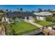Waterfront home featuring a manicured lawn, a patio, and a private dock at 240 N Julia Cir, St Pete Beach, FL 33706