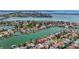Expansive aerial view features a waterfront residential area with private boat docks and easy access to open water at 240 N Julia Cir, St Pete Beach, FL 33706