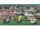 Lovely waterfront home with a green lawn, boat dock, and tropical landscaping in a coastal neighborhood at 240 N Julia Cir, St Pete Beach, FL 33706