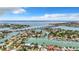 Expansive aerial view of a waterfront community with a bridge, canal system, and ocean views at 240 N Julia Cir, St Pete Beach, FL 33706