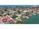 Captivating aerial view showcasing waterfront homes with private docks and lush landscaping in a coastal community at 240 N Julia Cir, St Pete Beach, FL 33706