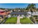 Beautiful backyard with manicured lawn, walkway to home, and patio sitting area, perfect for enjoying Florida sunshine at 240 N Julia Cir, St Pete Beach, FL 33706