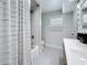 Well-designed bathroom with a double sink vanity, tub-shower, and contemporary finishes at 240 N Julia Cir, St Pete Beach, FL 33706
