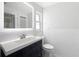 Bathroom features a sleek vanity, mirror, subway tile walls and tiled floor at 240 N Julia Cir, St Pete Beach, FL 33706
