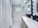Stylishly appointed bathroom with double sinks, sleek fixtures, and a shower-tub combination at 240 N Julia Cir, St Pete Beach, FL 33706