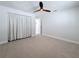 Well-lit bedroom featuring plush carpeting, ceiling fan, and neutral color palette at 240 N Julia Cir, St Pete Beach, FL 33706