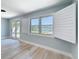 Bedroom featuring neutral tones, plantation shutters and a view of the water at 240 N Julia Cir, St Pete Beach, FL 33706