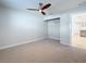 A bedroom features neutral tones, a ceiling fan, carpet, and a closet, providing a blank canvas at 240 N Julia Cir, St Pete Beach, FL 33706