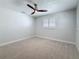 Spacious bedroom with carpet, ample natural light, and ceiling fan at 240 N Julia Cir, St Pete Beach, FL 33706