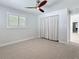 Bright bedroom with modern ceiling fan, shuttered windows, and carpet floors at 240 N Julia Cir, St Pete Beach, FL 33706