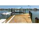 Exterior view of dock, with fishing station and boat lift on the water at 240 N Julia Cir, St Pete Beach, FL 33706