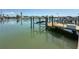 Home dock featuring a boat lift overlooking the water at 240 N Julia Cir, St Pete Beach, FL 33706