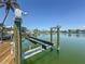 Home dock with boat lift overlooking the water at 240 N Julia Cir, St Pete Beach, FL 33706