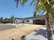 Charming single-story home featuring a modern garage door, well-maintained driveway, and lush landscaping at 240 N Julia Cir, St Pete Beach, FL 33706