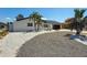 Beautiful single-story home with a modern garage door, well-maintained driveway, and charming landscaping at 240 N Julia Cir, St Pete Beach, FL 33706
