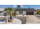 Charming single-story home with manicured landscaping, modern garage door, and a well-maintained driveway at 240 N Julia Cir, St Pete Beach, FL 33706