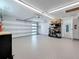 Bright and clean garage with epoxy flooring, storage shelving, and ample space for vehicles at 240 N Julia Cir, St Pete Beach, FL 33706