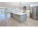 Large kitchen island with gray cabinetry, a white countertop, and stainless steel appliances at 240 N Julia Cir, St Pete Beach, FL 33706