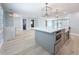 Large kitchen island features stainless oven and sink, with pendant lighting and dining space nearby at 240 N Julia Cir, St Pete Beach, FL 33706