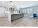 Open concept kitchen with island, stainless steel appliances, and modern lighting at 240 N Julia Cir, St Pete Beach, FL 33706