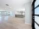 Open-concept kitchen features a spacious island, stainless steel appliances, and wood flooring at 240 N Julia Cir, St Pete Beach, FL 33706