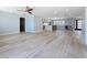 Spacious open floor plan with hardwood floors leading to the kitchen and entry way at 240 N Julia Cir, St Pete Beach, FL 33706