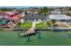 Stunning backyard and private boat dock offers direct access to the water, complemented by lush tropical landscaping at 240 N Julia Cir, St Pete Beach, FL 33706