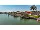 Idyllic waterfront homes and docks create a serene scene, with lush landscaping enhancing the coastal charm at 240 N Julia Cir, St Pete Beach, FL 33706