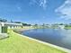 Scenic view of pond with fountain feature and manicured lawn surrounding the property at 1223 Queen Anne Dr # C, Palm Harbor, FL 34684