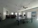 Recreation room featuring ping pong table, lounge area and ample natural light at 1223 Queen Anne Dr # C, Palm Harbor, FL 34684
