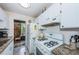 Well-equipped kitchen with granite countertops and white cabinets at 5969 Terrace Park N Dr # 304, St Petersburg, FL 33709