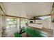 Covered outdoor kitchen area with picnic tables and a grill at 5969 Terrace Park N Dr # 304, St Petersburg, FL 33709