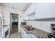 Well-equipped kitchen with granite countertops and white cabinets at 5969 Terrace Park N Dr # 304, St Petersburg, FL 33709