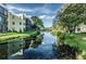 Serene canal views with lush landscaping and condo reflection at 5969 Terrace Park N Dr # 304, St Petersburg, FL 33709