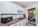 Well-equipped kitchen with granite countertops and white cabinets at 5969 Terrace Park N Dr # 304, St Petersburg, FL 33709