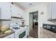 Well-equipped kitchen with granite countertops and white cabinets at 5969 Terrace Park N Dr # 304, St Petersburg, FL 33709