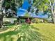 Ranch style home with lush landscaping and a spacious lawn at 1223 Queen Anne Dr # C, Palm Harbor, FL 34684