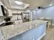 Updated kitchen features granite countertops, stainless steel appliances, and white cabinets at 1223 Queen Anne Dr # C, Palm Harbor, FL 34684