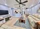 Open living room featuring light walls, a neutral color scheme and reclining sofas at 1223 Queen Anne Dr # C, Palm Harbor, FL 34684