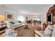 Open living area with hardwood floors, neutral colored furniture, and views to the dining area at 2284 Spanish Dr # 40, Clearwater, FL 33763