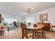 Dining room with wood table, chandelier, and view into the living room at 2284 Spanish Dr # 40, Clearwater, FL 33763