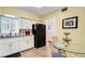 Eat in kitchen with white cabinets, stainless steel appliances, and breakfast table at 2284 Spanish Dr # 40, Clearwater, FL 33763